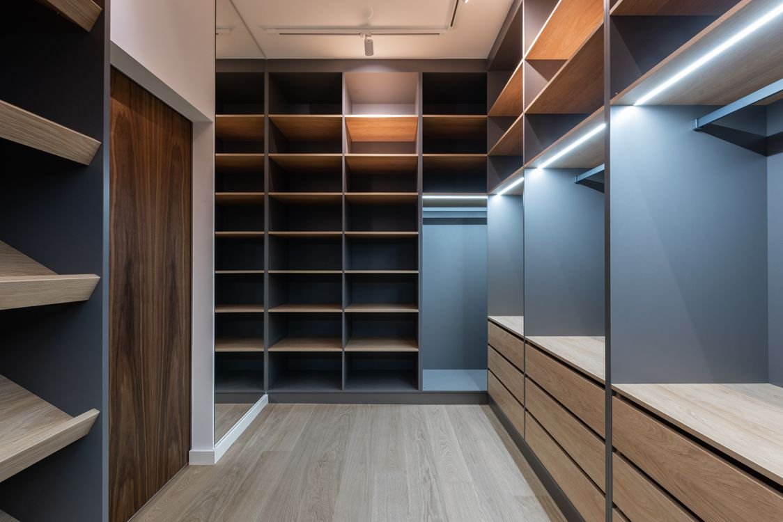 Wardrobe inspiration with organised hanging space, drawers and open shelving