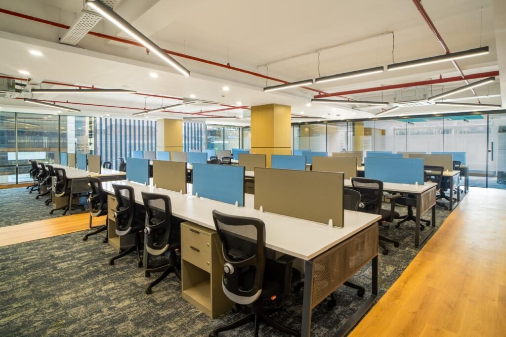 Open-plan workstations with blue privacy screens supplied by Kan Systems for Hatchlabs, Dehradun