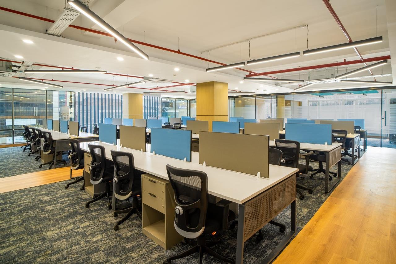 Open-plan workstations with blue privacy screens supplied by Kan Systems for Hatchlabs, Dehradun